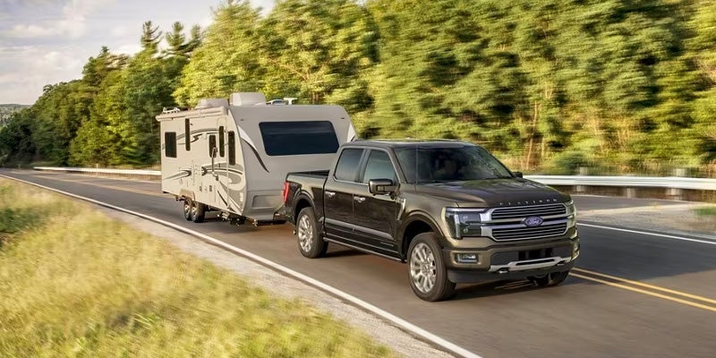 2024 Ford F-150 pulling camper on highway