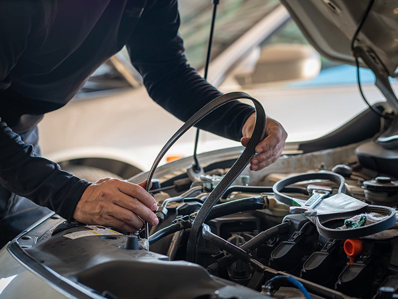 Service Technician Reparing the Car-Belt